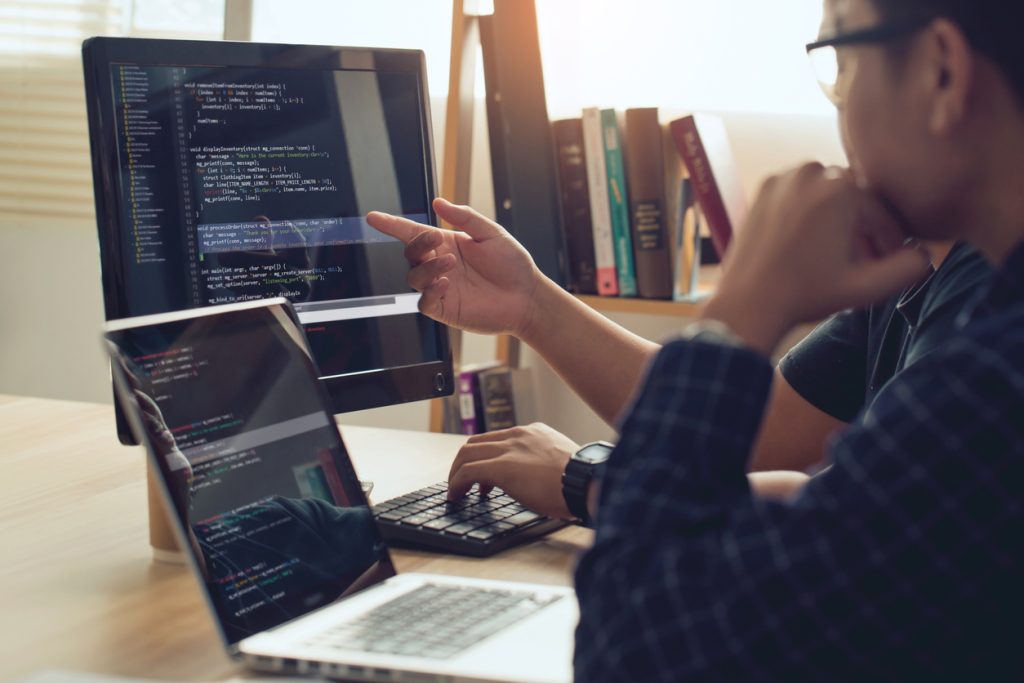 A person points at a computer.
